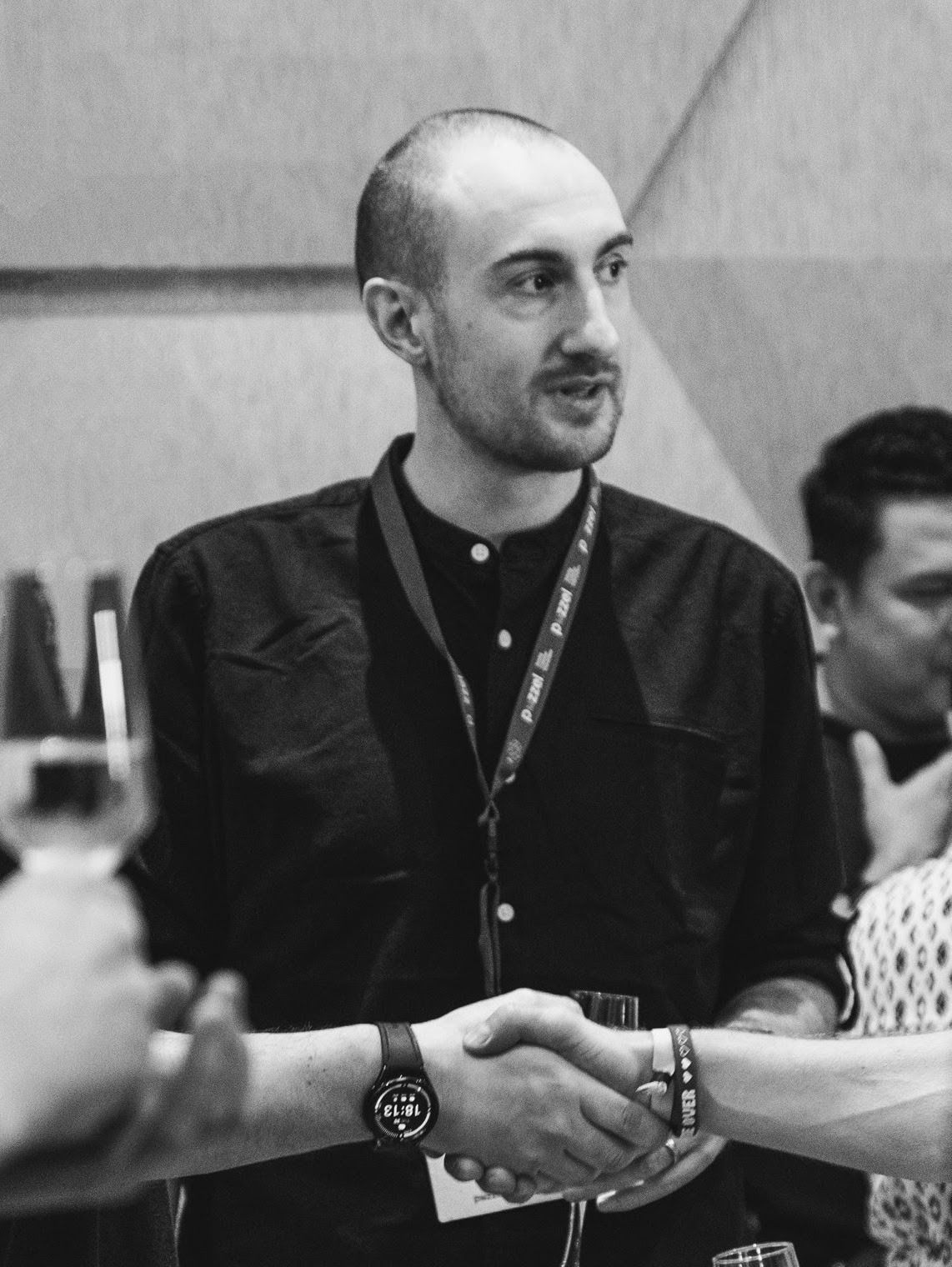 Marc Fenton talking with colleagues at a work event